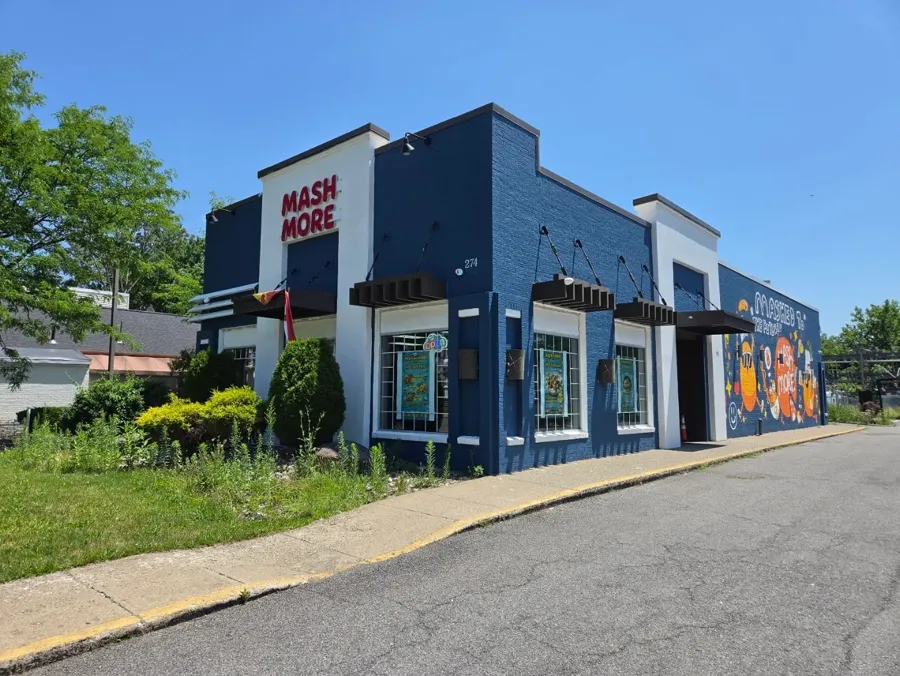 The MashMore storefront at 274 Delaware Ave: a blue and white building with red Mash More letters and a mural down the side